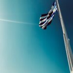 low angle shot of a the greek flag on a flag pole