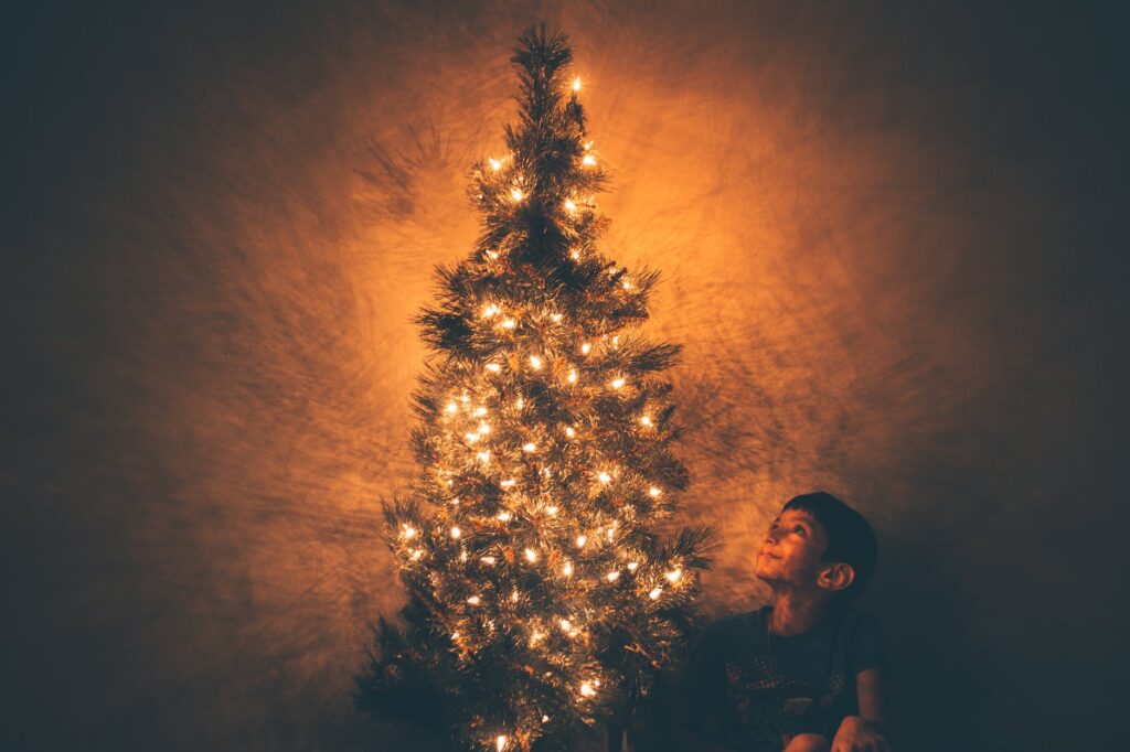 boy beside christmas tree illustration